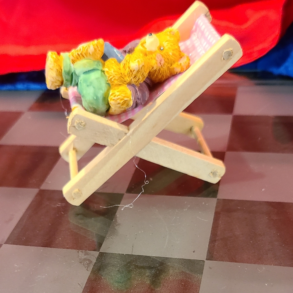 Cutie pie bear sitting in beach chair wood chair
